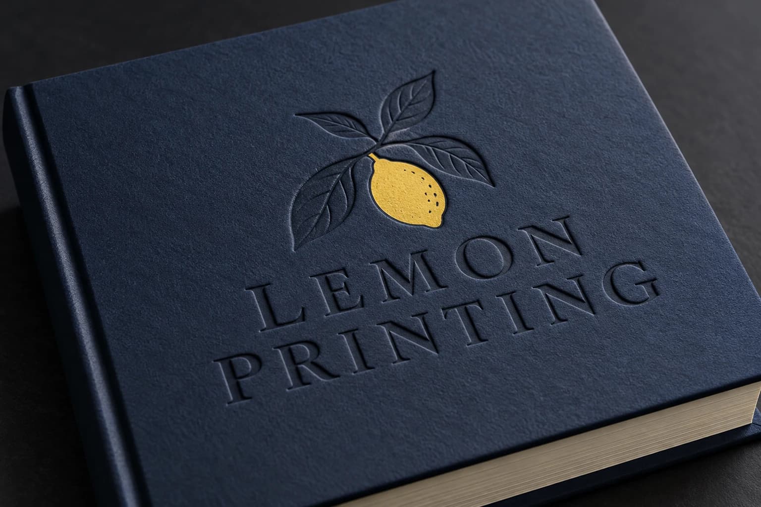 Recessed lemon motif on a navy paper-wrapped book cover; AI-generated finish illustration for Lemon Printing